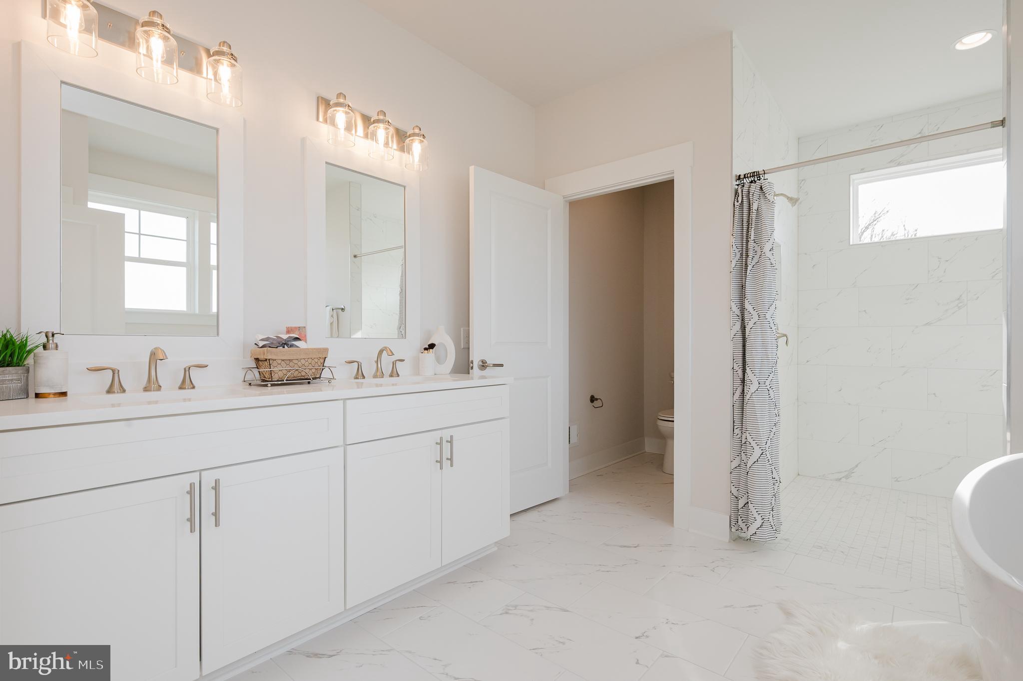 1605 A Oakland Road Freeland, MD 21053 - Photo 25 of 32 a bathroom with a double vanity sink a toilet and a mirror