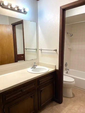 a bathroom with a sink a toilet and a bathtub