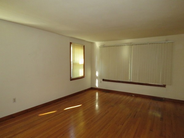 747 North Branch Parkway Springfield, MA 01119 - Photo 11 of 18 an empty room with wooden floor and windows