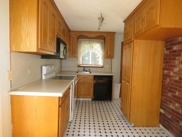 747 North Branch Parkway Springfield, MA 01119 - Photo 10 of 18 a kitchen with a sink a refrigerator and cabinets