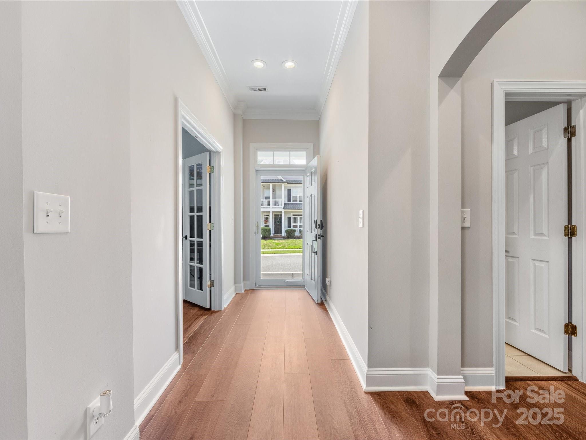 4148 Cedar Point Avenue Matthews, NC 28104 - Photo 3 of 48 a view of a hallway with wooden floor and a bathroom