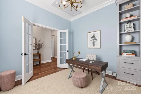 a living room with furniture chandelier and a fireplace