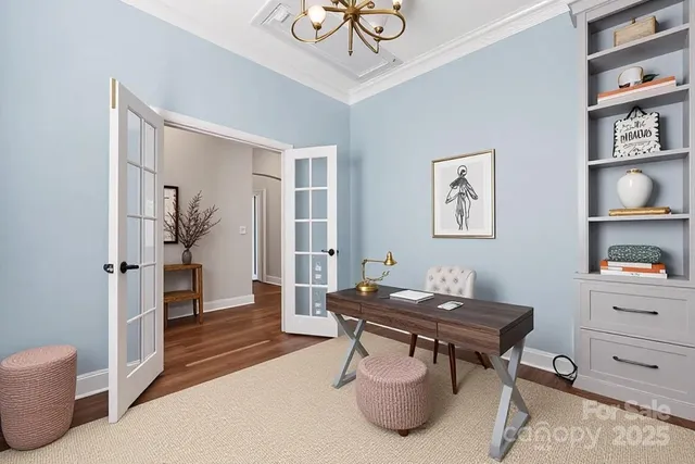 a living room with furniture chandelier and a fireplace