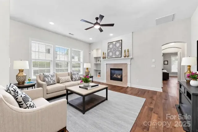 a view of empty room with wooden floor and window