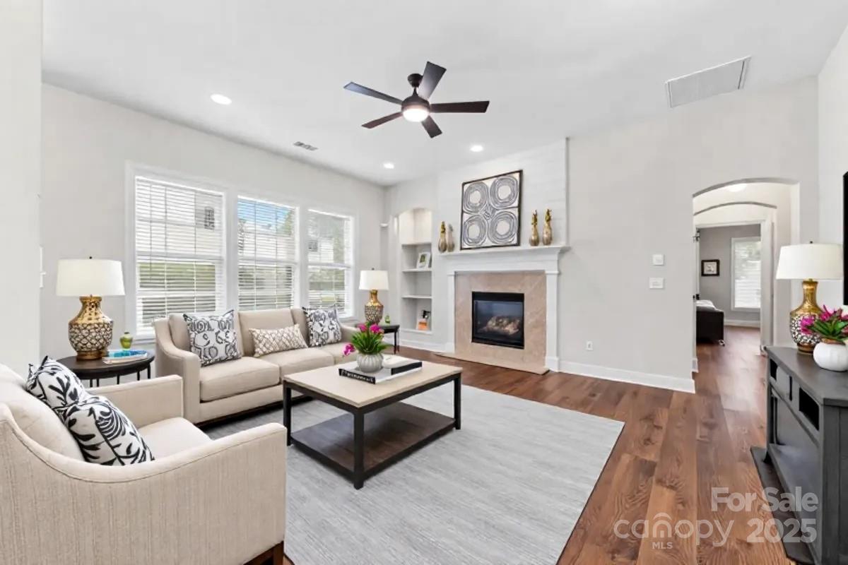 4148 Cedar Point Avenue Matthews, NC 28104 - Photo 7 of 48 a living room with furniture fireplace and a large window