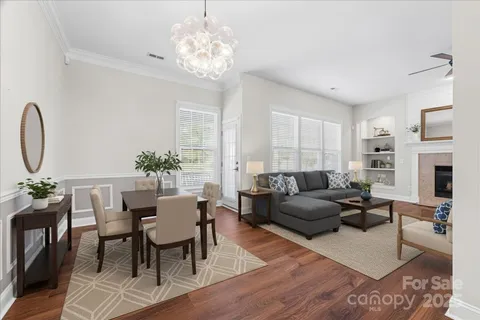 a kitchen with stainless steel appliances granite countertop a refrigerator a stove a sink dishwasher and a wooden floor