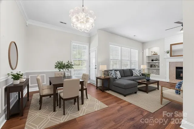 a kitchen with stainless steel appliances granite countertop a refrigerator a stove a sink dishwasher and a wooden floor