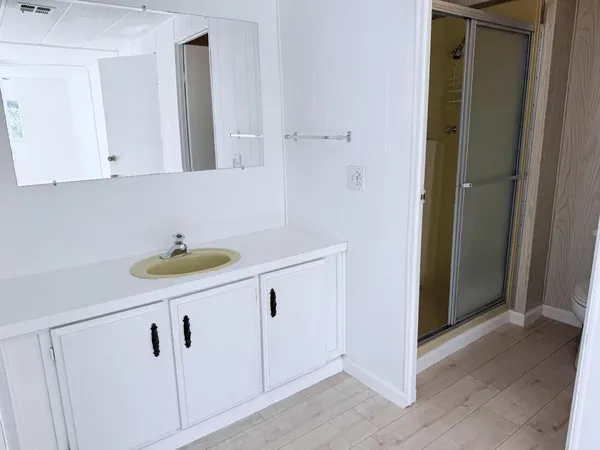 a room with white cabinets and sink