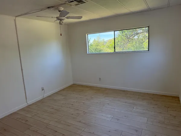 a view of room with hardwood floor and window