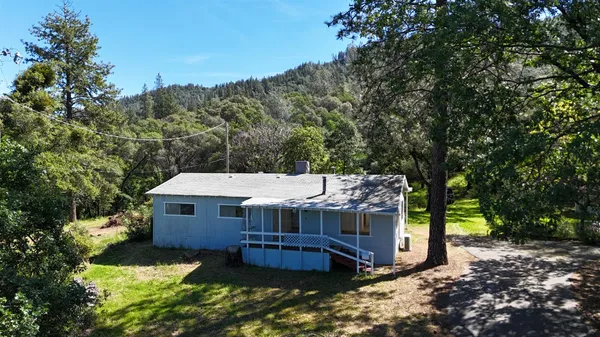 an aerial view of a house with a yard