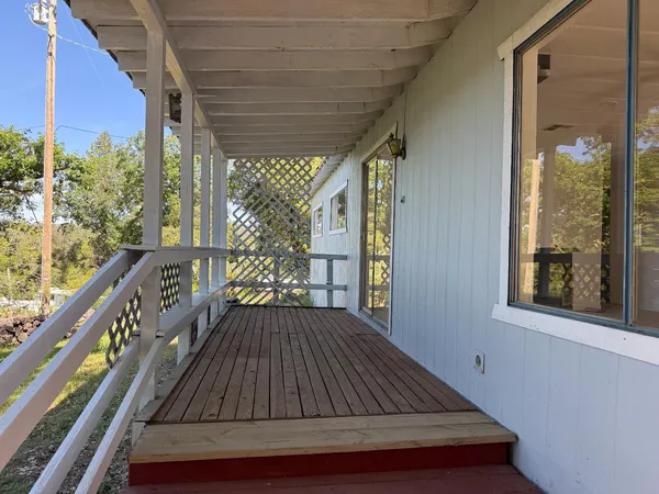 a view of balcony with wooden floor