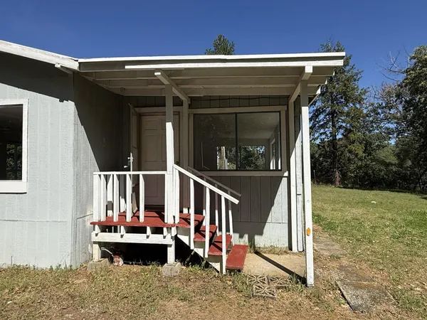 a view of house with outdoor seating and city view