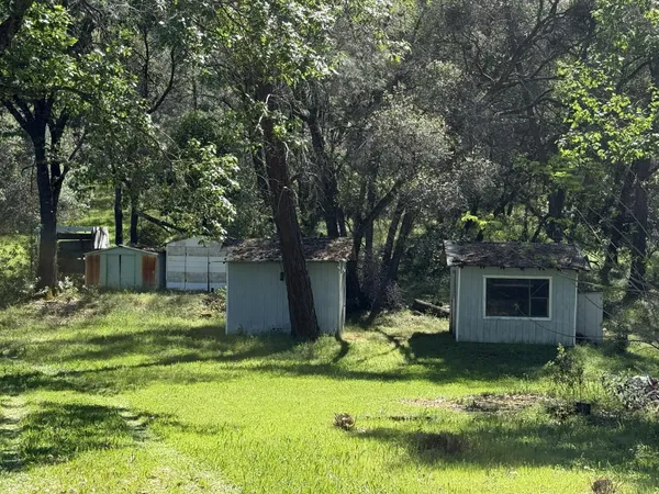 a backyard of a house with swimming pool and a fire pit