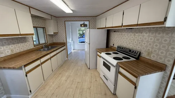 a kitchen that has a sink and a stove