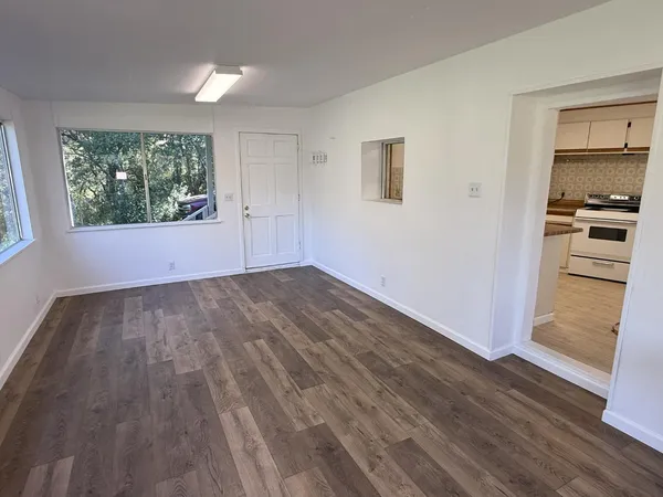 wooden floor in an empty room with a window