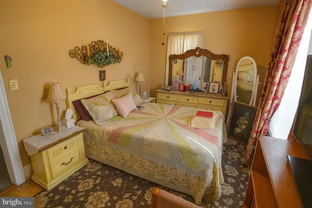 a bedroom with a bed and dresser