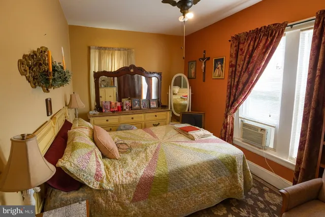 a bed sitting in a bedroom next to a window