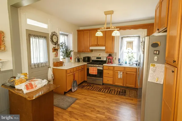 a kitchen with sink refrigerator and window