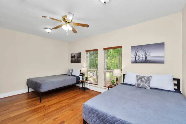 a bedroom with furniture and a large window