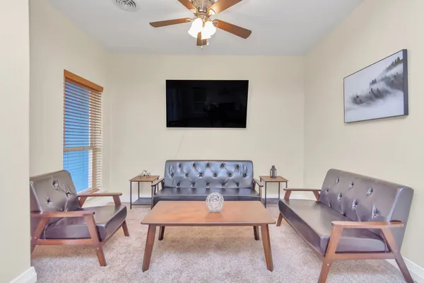 a living room with furniture and a flat screen tv