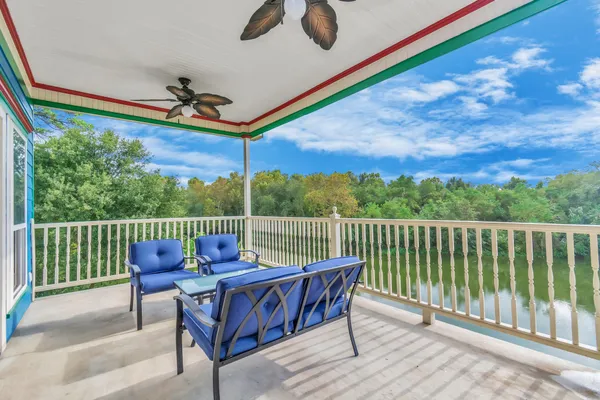 a view of a chairs and table in the roof deck