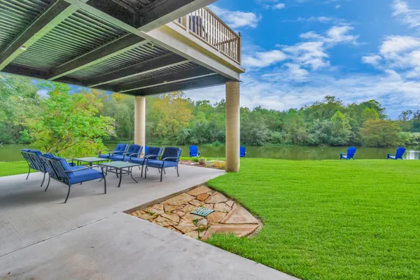 a view of a yard with furniture and garden