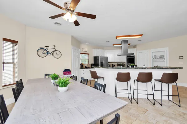 a kitchen with a dining table and chairs
