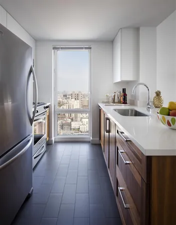 a kitchen with stainless steel appliances granite countertop a sink stove and refrigerator
