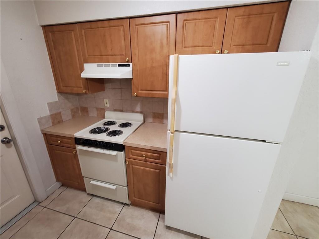 2607 Northeast 8th Avenue, Unit 7 Wilton Manors, FL 33334 - Photo 20 of 23 a white refrigerator freezer sitting inside of a kitchen