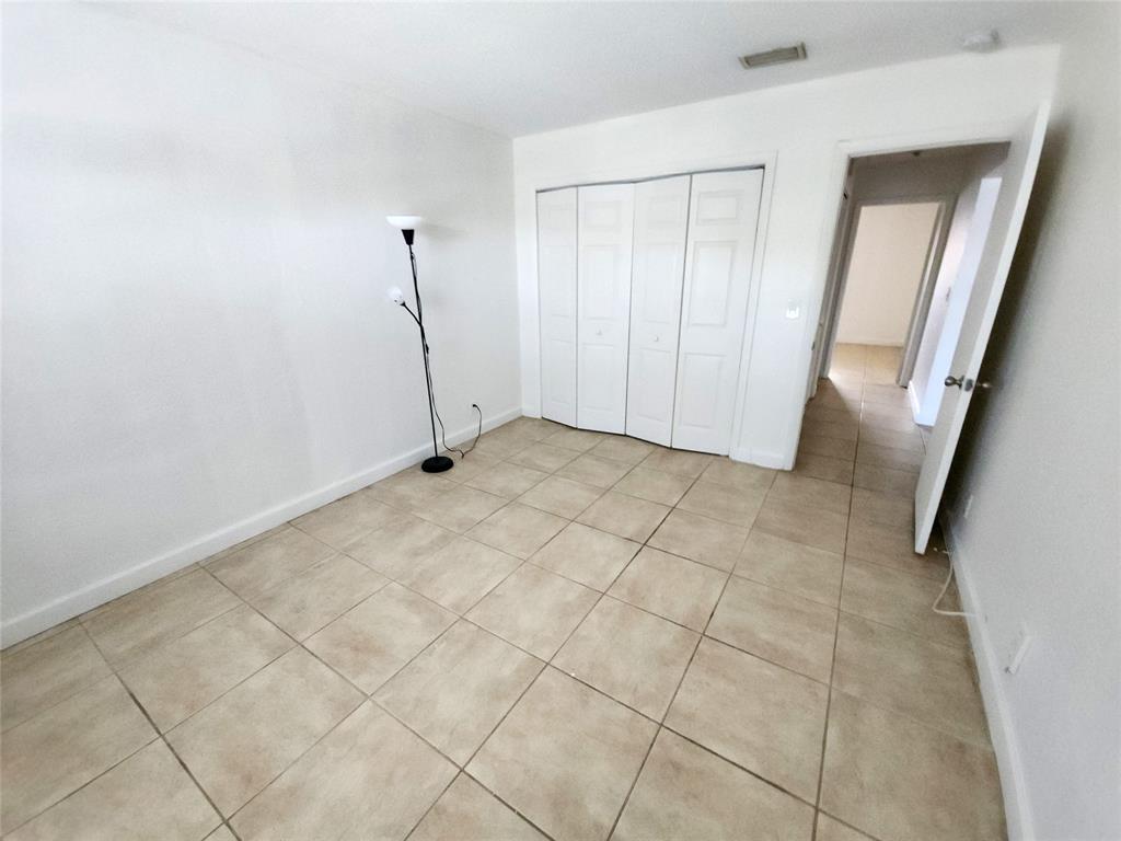 2607 Northeast 8th Avenue, Unit 7 Wilton Manors, FL 33334 - Photo 21 of 23 a view of an empty room with wooden floor