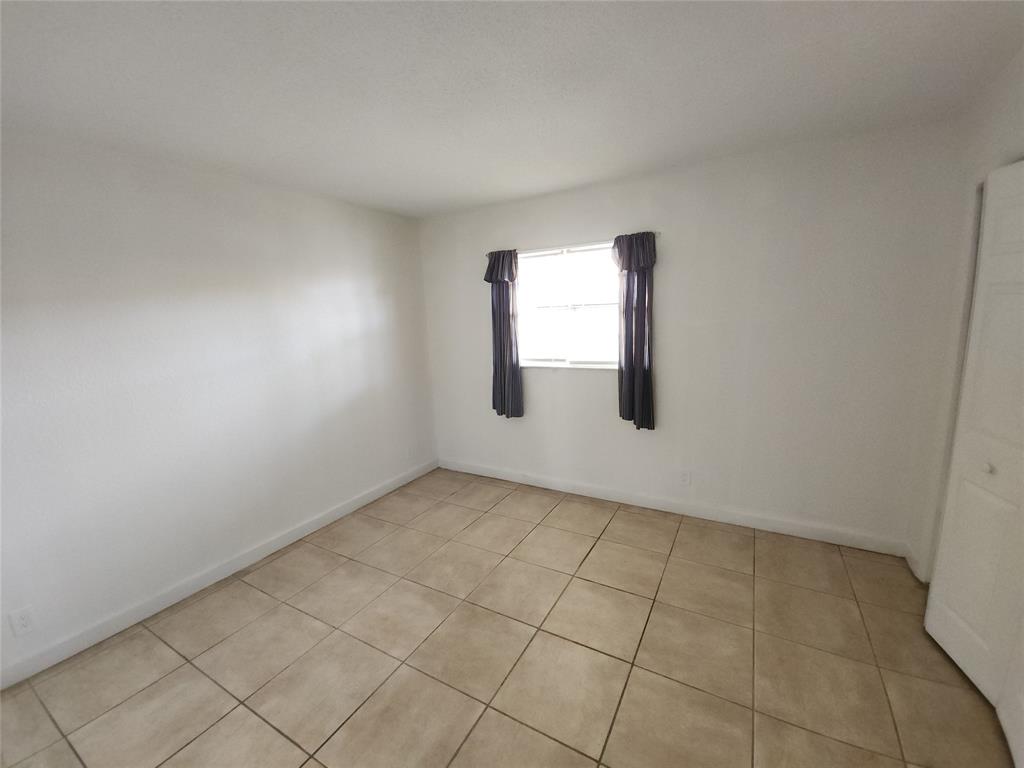 2607 Northeast 8th Avenue, Unit 7 Wilton Manors, FL 33334 - Photo 23 of 23 an empty room with windows