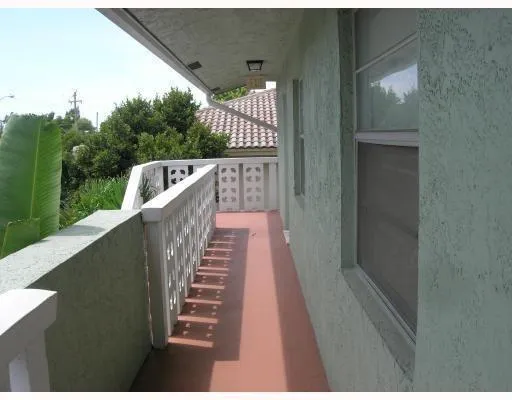 a view of balcony with wooden floor
