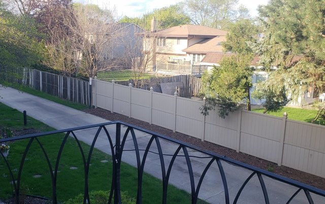 714 East Algonquin Road, Unit J205 Arlington Heights, IL 60005 - Photo 2 of 14 a view of a wooden fence and a couple of street view