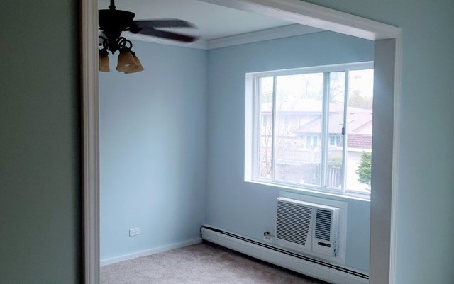 714 East Algonquin Road, Unit J205 Arlington Heights, IL 60005 - Photo 7 of 14 a view of a livingroom with a window