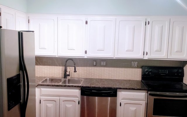 714 East Algonquin Road, Unit J205 Arlington Heights, IL 60005 - Photo 8 of 14 a kitchen with granite countertop white cabinets and stainless steel appliances