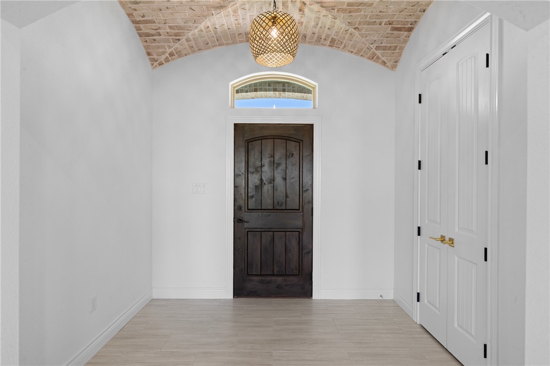 6524 Agave Court Bryan, TX 77808 - Photo 12 of 43 Foyer entrance featuring lofted ceiling and light wood-style flooring