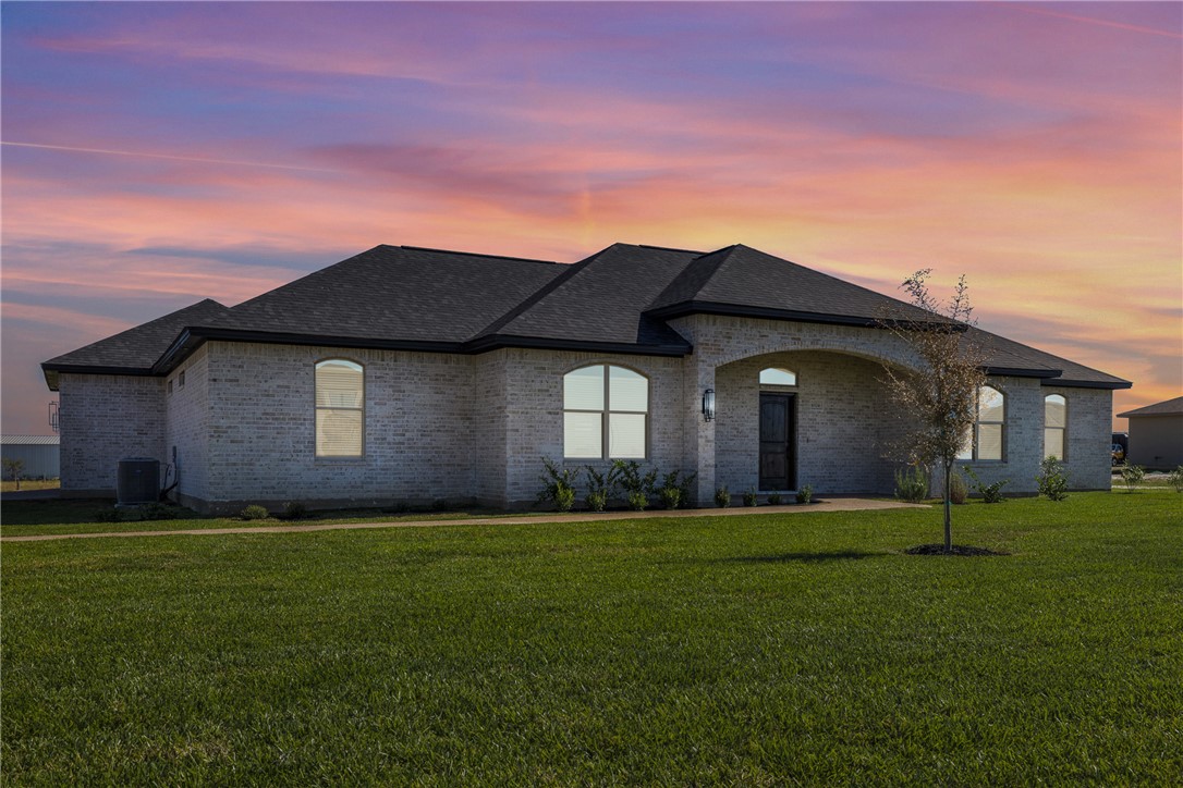 6524 Agave Court Bryan, TX 77808 - Photo 2 of 43 French country home with a front lawn, brick siding, and a shingled roof