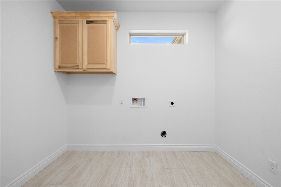 6524 Agave Court Bryan, TX 77808 - Photo 23 of 43 Laundry area with hookup for a washing machine, electric dryer hookup, and cabinet space
