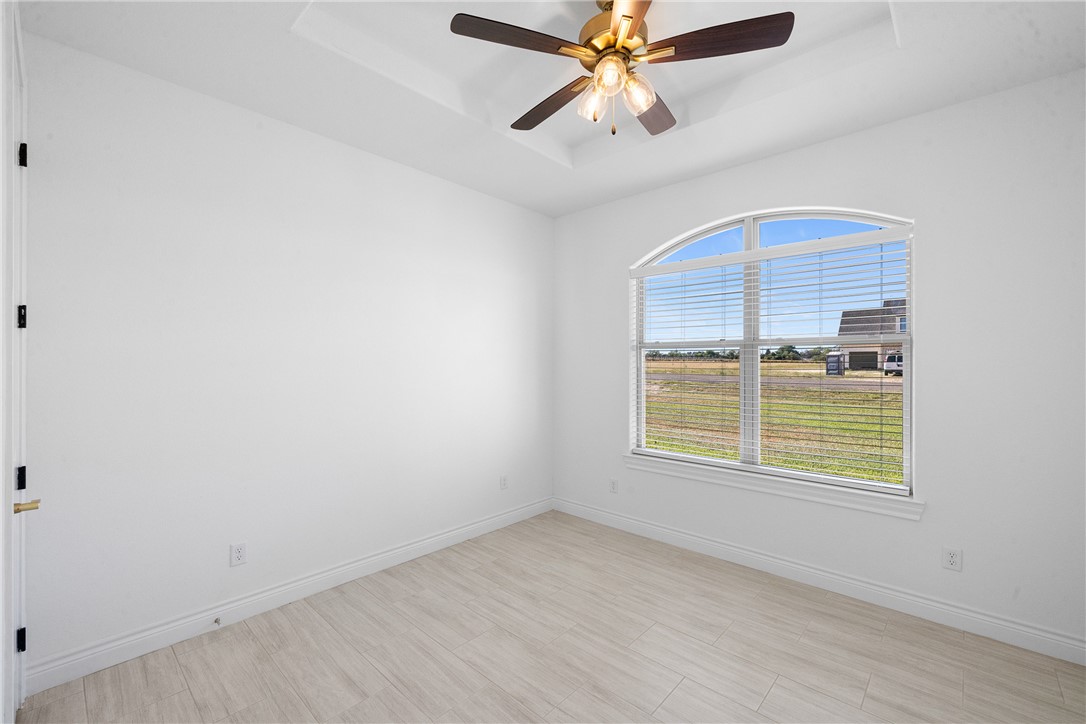 6524 Agave Court Bryan, TX 77808 - Photo 26 of 43 Spare room with a raised ceiling, light wood finished floors, and a ceiling fan