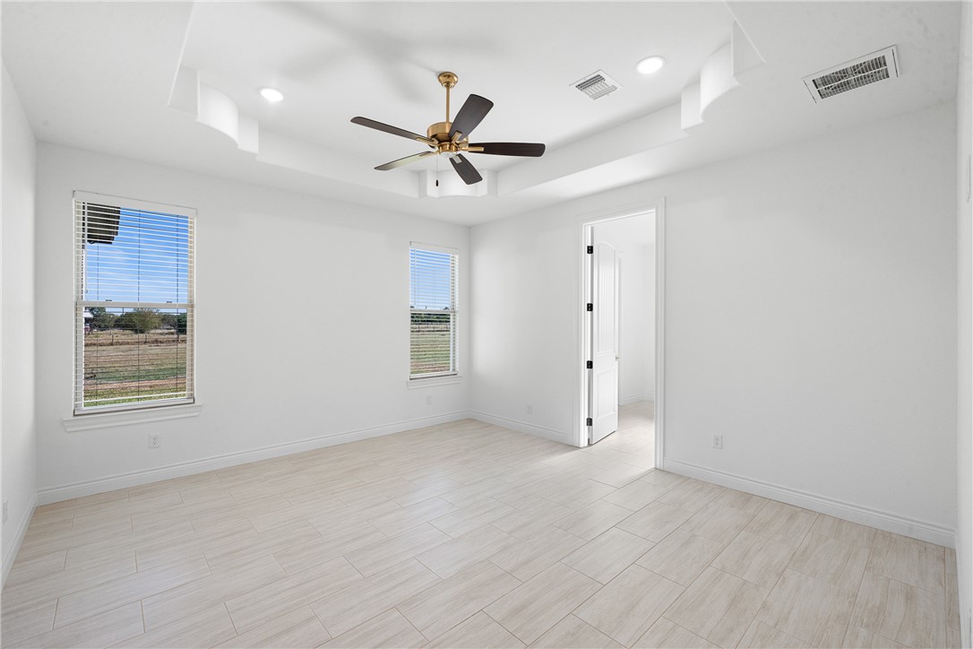6524 Agave Court Bryan, TX 77808 - Photo 27 of 43 Spare room featuring a raised ceiling, wood tiled floors, ceiling fan, and recessed lighting