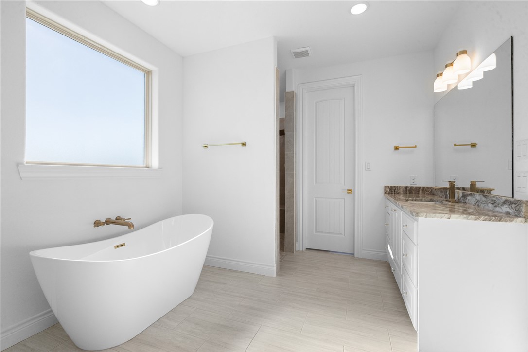 6524 Agave Court Bryan, TX 77808 - Photo 29 of 43 Bathroom with vanity, a freestanding tub, and recessed lighting
