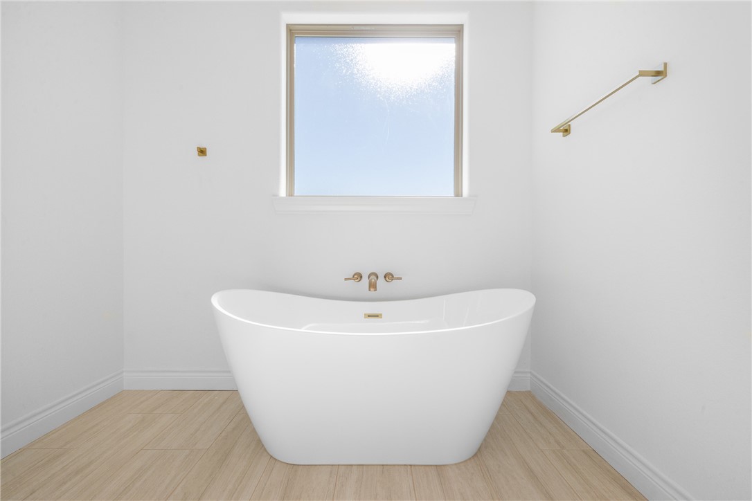 6524 Agave Court Bryan, TX 77808 - Photo 31 of 43 Full bathroom with a soaking tub and light wood-style floors