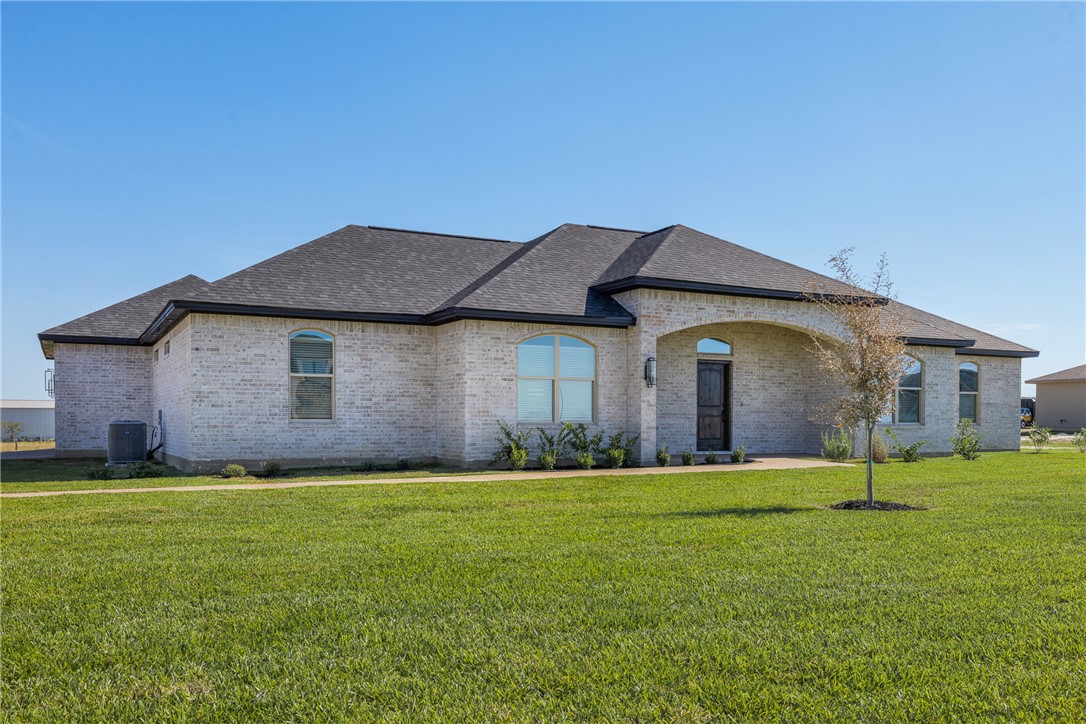 6524 Agave Court Bryan, TX 77808 - Photo 4 of 43 French country home with a front lawn, brick siding, and a shingled roof