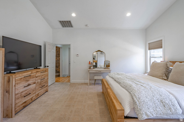 1504 Rome Way Apple Valley, UT 84737 - Photo 11 of 22 Spacious room featuring vaulted ceilings, recessed lighting, wall-to-wall carpeting, and a window with a roller shade