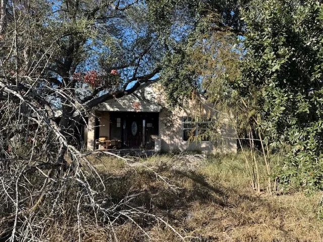 a front view of a building with trees