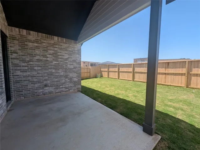 a kitchen with granite countertop white cabinets and stainless steel appliances