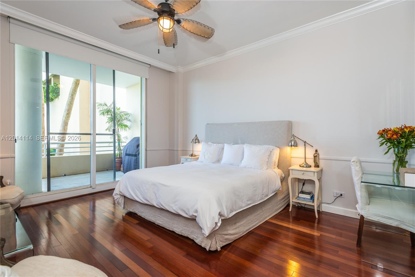 888 Brickell Key Drive, Unit 211 Miami, FL 33131 - Photo 11 of 28 a bedroom with a large bed and a chandelier