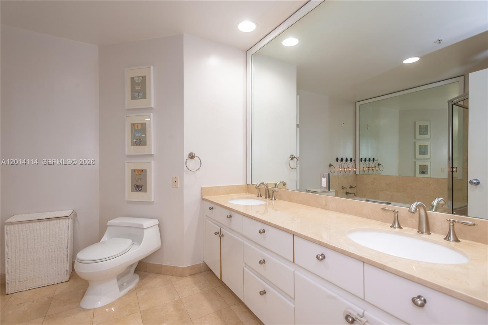 888 Brickell Key Drive, Unit 211 Miami, FL 33131 - Photo 15 of 28 a spacious bathroom with a granite countertop sink a toilet and a mirror