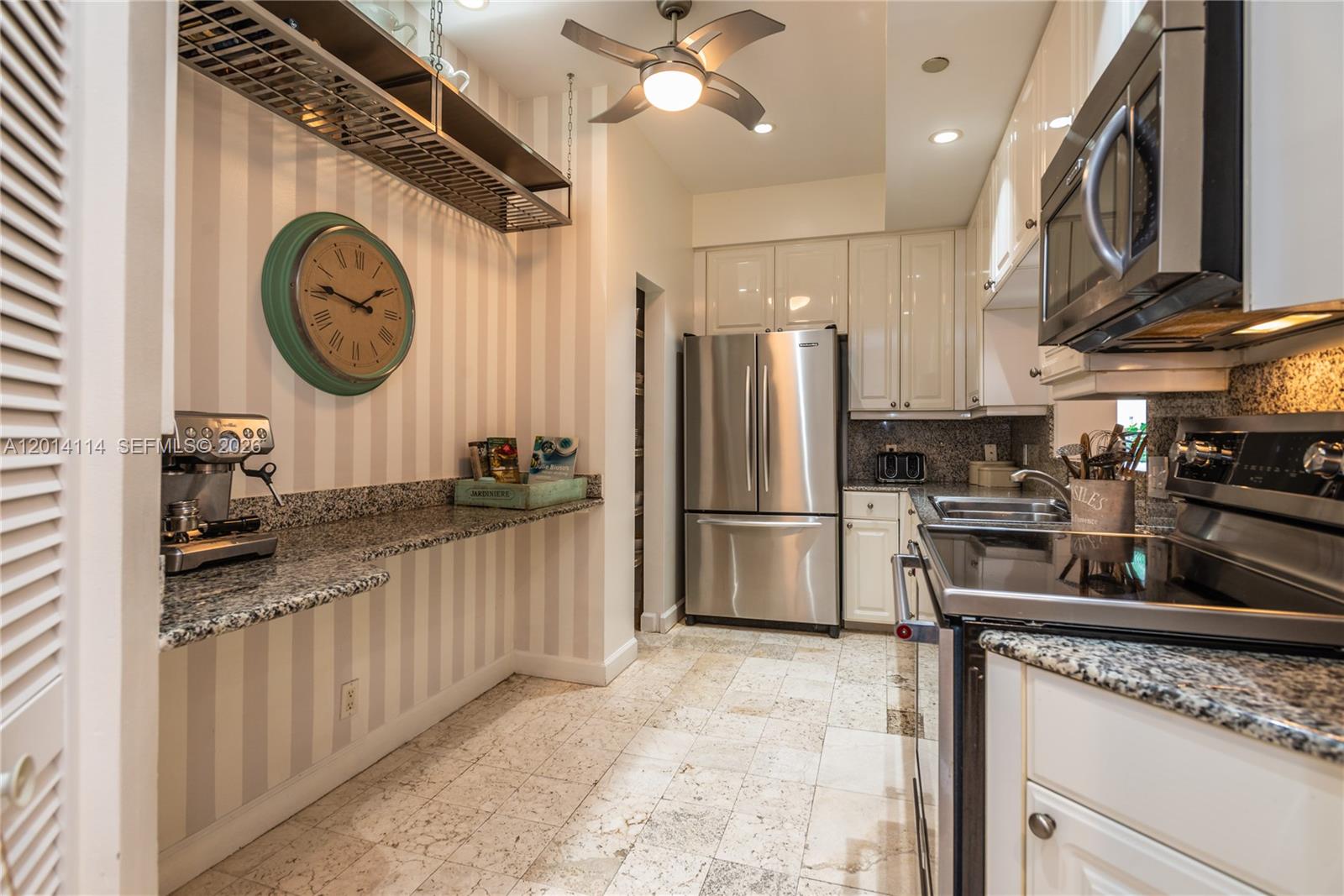 888 Brickell Key Drive, Unit 211 Miami, FL 33131 - Photo 8 of 28 a kitchen with stainless steel appliances granite countertop a sink a stove and refrigerator