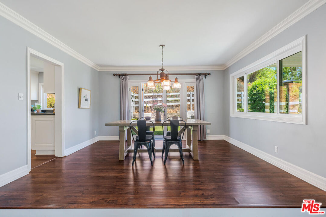 24975 Kit Carson Road Hidden Hills, CA 91302 - Photo 11 of 38 a view of a dining room with furniture window and wooden floor